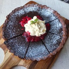 a dessert is on a wooden board with powdered sugar