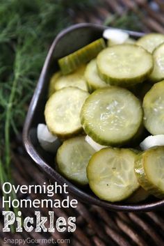 cucumbers and onions in a metal bowl on a wicker mat with the words overnight homemade pickles