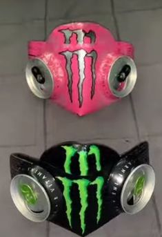 two monster trucks with green and pink designs on them, one is black and the other is red