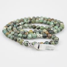 AFRICAN TURQUOISE 108 BEAD MALA WITH CLEAR QUARTZ POINT TASSEL: Enjoy this beautiful 108 beaded mala made with 8mm african turquoise beads, silver spacers and a unique clear quartz crystal point as a tassel; great for healing, spirituality, yoga and deeper meditation. A classy "One Of A Kind” piece that comes in a gift box! Mood: God Bless MANTRA RECITING: Hold your mala in your right hand, draped between your middle and index fingers. Starting at the guru bead, use your thumb to count each smal Healing Spirituality, 108 Mala Beads, Clear Quartz Point, Turquoise Bead Necklaces, African Turquoise, 108 Bead, Mala Beads, Clear Quartz Crystal, Prayer Beads