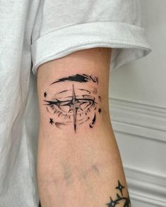 a person with a compass tattoo on their leg