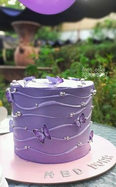 a purple cake sitting on top of a table