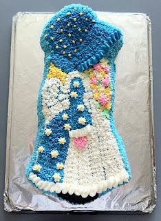 a cake shaped like a dress with flowers on it