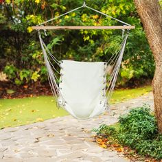 a white hammock hanging from a tree