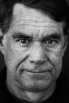 a black and white photo of a man's face with wrinkles on it