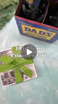 an old photo with a green bow on it next to a fathers day gift box