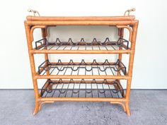 a bamboo wine rack with several bottles on the top and bottom shelves, all stacked together