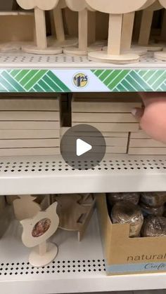 a person is picking out some food from the shelves in a store with other items