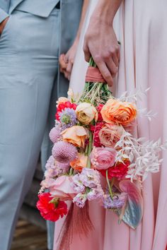 the bride and groom are holding their bouquets