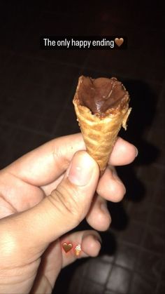 someone is holding an ice cream cone with chocolate frosting on it and the caption says, the only happy ending