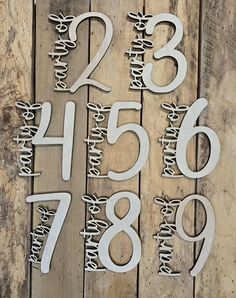 the numbers are made out of wood and have been cut into smaller letters with scissors