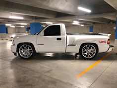 a white truck parked in a parking garage