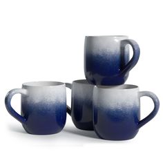 four blue and white coffee mugs stacked on top of each other with one cup in the middle