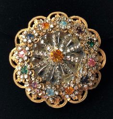 "Here is a rare and very pretty vintage brooch designed by Frank Hess, head designer for Miriam Haskell. This brooch bears the designer's highly sought after horse shoe signature which was only briefly used (1948 - 1950), making this a highly collectible piece. The brooch is beautifully crafted in a gorgeous floral pattern that incorporates glittering rhinestones in multiple colors, shimmering clear crystal rose montees and smooth translucent grey-blue stones. The stone setting is in an enchanti Vintage Rhinestone Brooches For Vintage Events, Vintage Multi-stone Brooches For Formal Occasions, Vintage Multicolor Wedding Brooches, Victorian Jeweled Brooches For Party, Vintage Multi-stone Gold Brooches, Vintage Gold Multi-stone Brooches, Multicolor Costume Jewelry Brooches For Weddings, Antique Rhinestones Brooch For Vintage Events, Antique Rhinestone Brooches For Vintage Events