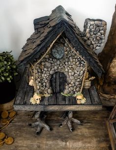 a bird house made out of wood and rocks