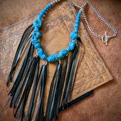 Nwt From My Craft Boutique Handcrafted Boho Western Turquoise Color Stone Chunk Beaded Necklace W Black Pu Leather Fringe Toggle Clasp 22" Long 7" Additional In Length For Fringe Unique One Of A Kind Design Black Southwestern Necklaces For Festivals, Black Southwestern Necklace For Festival, Southwestern Style Black Necklace For Festivals, Southwestern Style Black Necklace For Festival, Turquoise Jewelry With Black Beads For Festival, Handmade Adjustable Black Turquoise Necklace, Bohemian Adjustable Black Turquoise Necklace, Faceted Glass Bead Necklace, Craft Boutique