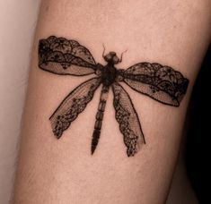 a black and white photo of a dragonfly tattoo