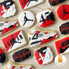 decorated cookies are arranged in the shape of jordan's shoes and nikes on display