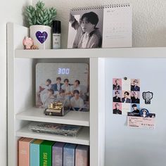 a book shelf filled with books and magnets