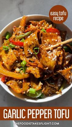 garlic pepper tofu in a white bowl with chopsticks on the side and text overlay