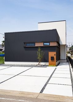 a black and white house with wood accents