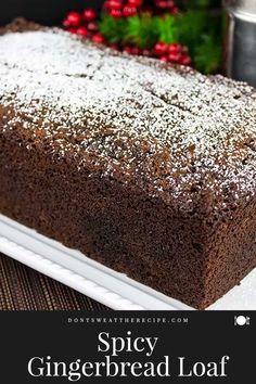 a loaf of spicey gingerbread loaf on a white plate with the words spicy gingerbread loaf above it