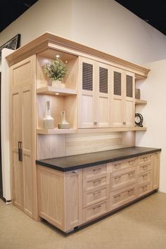 an empty kitchen with wooden cabinets and black countertop space in front of the cupboards