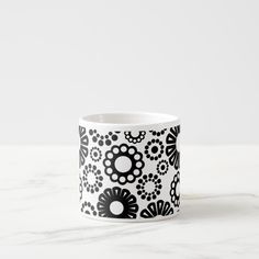 a black and white flower pattern on a cup