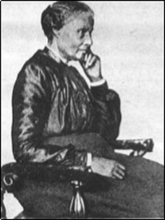 an old black and white photo of a woman sitting in a chair talking on the phone