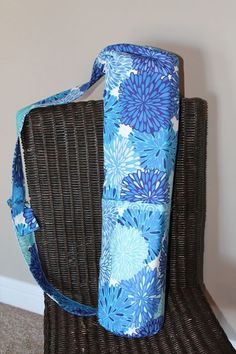 a large blue bag sitting on top of a wicker chair next to a wall