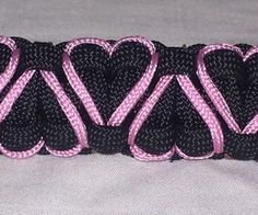 two hearts on black and pink ribbon with white stitching in the center that says love