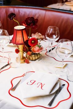 a table set with place settings and wine glasses