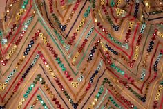 beaded fabric with many different colors and designs on it's edges, including beads