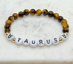 TAURUS ♉️ April 20 - May 20 TIGERS EYE: AKA "the stone of courage". for protection & courage - has the power to focus the mind - promotes mental clarity - helps resolve problems & increases ability to make decisions - unclouds emotions - repels negative energies, especially  low-vibrational negative energies  Chakra: Sacral & Solar Plexus  -21 other crystal options available to choose from, if you don't see an option available that would like for your bracelet, message me and I will accommodate Taurus Bracelet, Taurus April, Tigers Eye Crystal, Bracelet Message, Tiger Eye Crystal, Gemstone Beads Jewelry, Tiger Eye Beads, Solar Plexus, April 20