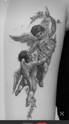 an angel tattoo on the back of a woman's arm