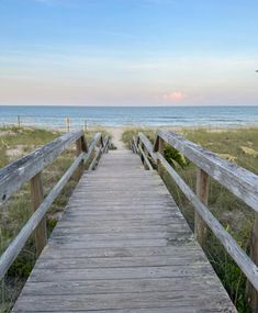 a wooden walkway leading to the beach