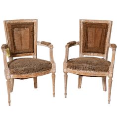 two wooden chairs sitting next to each other