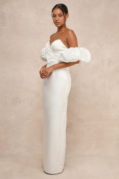 Ensure that your big day is truly unforgettable with a pristine look like the Lulus Profound Love White Satin Pleated Puff Sleeve Maxi Dress! Sleek woven satin lends a luxe essence to this gown that features a sweetheart-style neckline (with hidden no-slip strips) and a chic, pleated bodice with a surplice-inspired design, supportive padding, low-cut back, and side boning. The high, fitted waist tops a column skirt that falls to an elegant maxi hem with a flirty kick pleat at the back. If you're Taffeta Wedding Dress With Sweetheart Neckline, Glamorous Satin Dress For Debutante Ball, Wedding Taffeta Dress With Sweetheart Neckline, Wedding Dress With Sweetheart Neckline In Taffeta, Elegant Voluminous Ball Gown Dresses, Elegant Voluminous Satin Dress, Fitted Taffeta Evening Dress For Weddings, Fitted Taffeta Gown For Wedding, Elegant Taffeta Evening Dress For Wedding