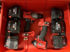 a red toolbox filled with different tools and power drill attachments on top of each other