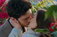 a man and woman kissing each other in front of colorful flowers with the caption fox