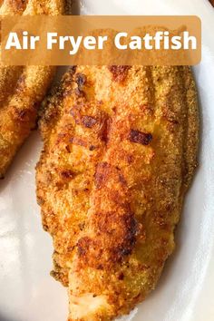 two fried fish on a white plate with the words air fryer catfish above it