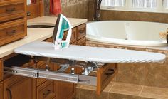 an ironing board sits on the edge of a bathtub