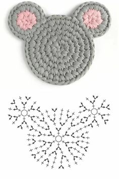 a crocheted mouse head with pink ears on it and an image of snowflakes in the background