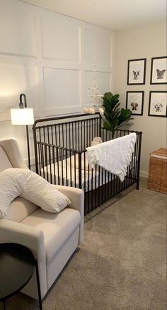 a baby's room with two cribs, a chair and pictures on the wall