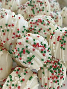 white chocolate covered with sprinkles and green and red candies on a plate