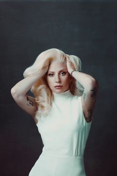 lady in white dress posing with hands on her head