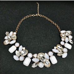 White and gold statement necklace Beautiful and unique fashion jewelry statement necklace. Crystal rhinestones and white translucent color accent pieces on gold tone chain. Can almost pass for a very very light lilac color but closest to white.  Length = 19 inches end to end. Front of necklace hangs 1 inch long. Adjustable lobster clasp.   10% discounts on bundles! Make offers through offer button only please! No trades. Any questions please ask. 💕 Jewelry Necklaces Unique Fashion Jewelry, Light Lilac, Gold Statement Necklace, Discount Jewelry, Jewelry Statement, Lilac Color, Purple Gold, Accent Pieces, Unique Fashion