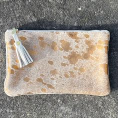 Now with free tassel pull on zip! (as shown in the first two photographs). This Fleuri makeup bag / mini clutch is a great versatile bag that is perfect for your phone, credit card and keys or to use as a stylish makeup bag. This makes a great 'grab and go' purse!  Dimensions: Height: 12cm (4.7in) Width: 20.5cm (8in) Flat construction The Fleuri clutch is made from metallic bronze cowhide on the front with soft cream leather on the back and a cream, starry lining on the inside. It is a flat cons Beige Mobile Phone Clutch Bag, Beige Mobile Phone Clutch, Gold Leather Pouch For Daily Use, Gold Leather Bags With Card Slots, Chic Gold Mobile Phone Clutch, Daily Use Gold Leather Pouch, Beige Pouch Clutch With Card Slots, Gold Leather Clutch With Mobile Phone Bag, Gold Leather Clutch For Mobile Phone