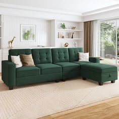 a living room with a large green sectional couch and pillows on top of the sofa