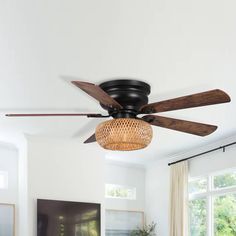 a ceiling fan with wicker shades in a living room